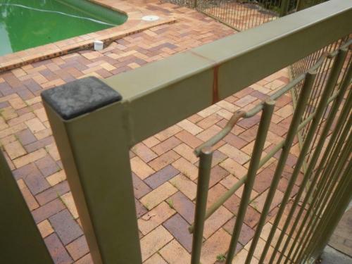 Weld broken away from top of metal pool gate