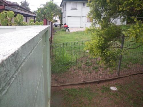 Climbable garden fence abuts a 1600mm block wall