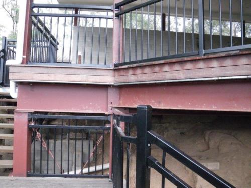 A child could climb from the upper level to the I beams then onto the fence on the second level before walking down the second flight of stairs to the pool area